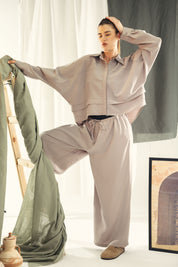 A wide leg copra pants with straw string for adjusting the waist Grey