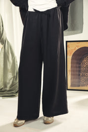 A wide leg copra pants with straw string for adjusting the waist Black