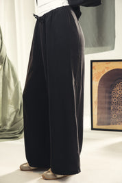 A wide leg copra pants with straw string for adjusting the waist Black
