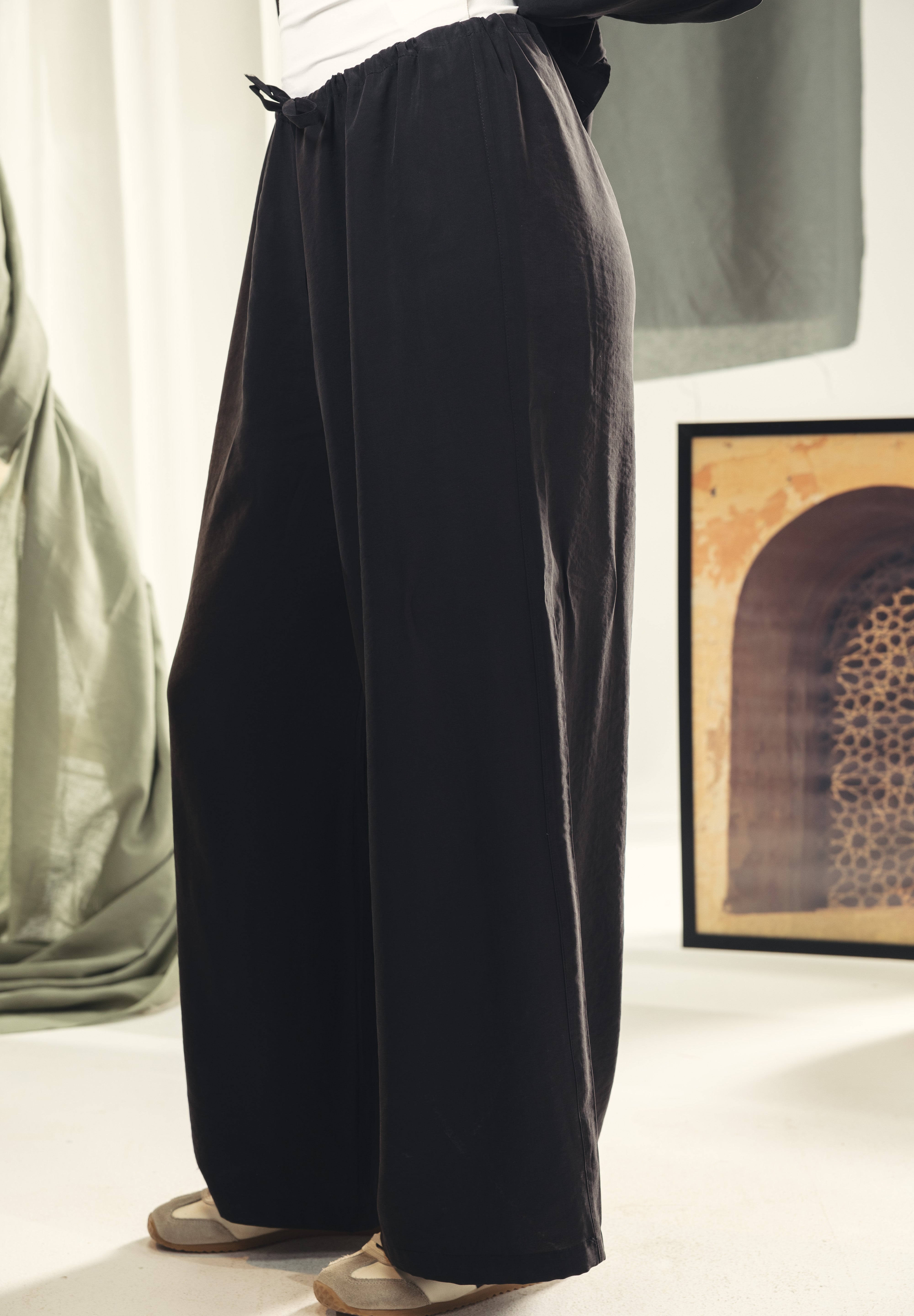 A wide leg copra pants with straw string for adjusting the waist Black